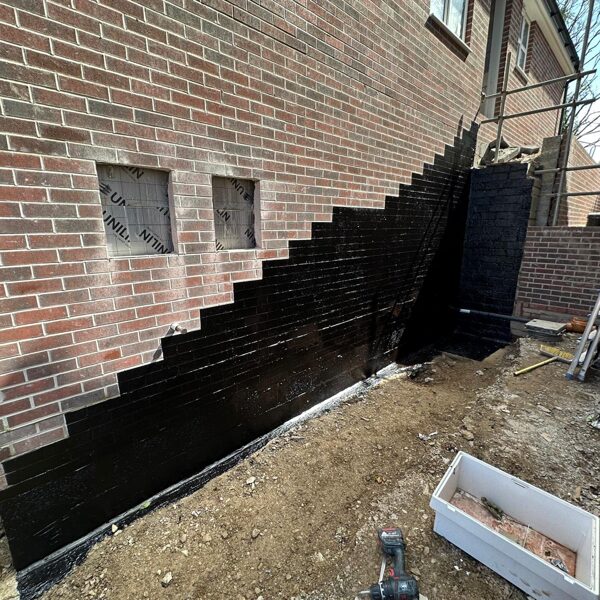 Atal 109LM to a wall where an external staircase is being installed, on a housing estate i