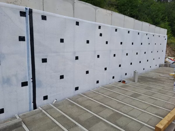Atal CM8 to internal face of a retaining wall to a site in Glamorgan. 