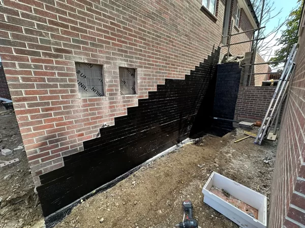 Atal 109LM to a wall where an external staircase is being installed, on a housing estate i